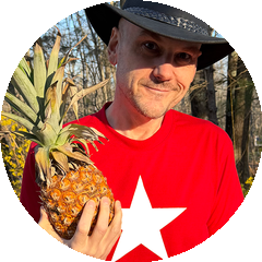 Jon Claude Haines holding a pineapple